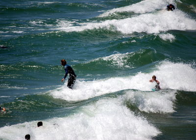 View of people surfing in the sea