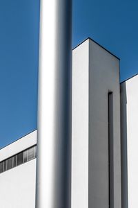 Low angle view of modern building against clear blue sky