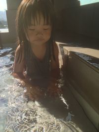 Cute girl looking at swimming pool