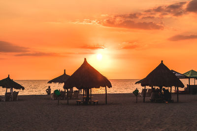 Scenic view of beach against sky during sunset