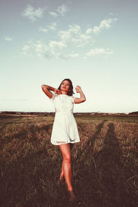 Full length of woman standing on field