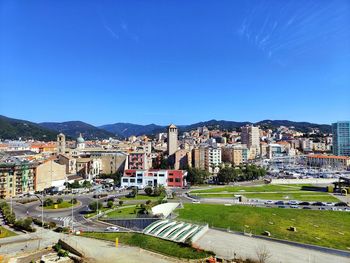 High angle view of townscape against clear blue sky