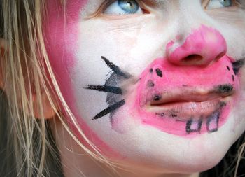 Close-up of girl with face paint looking away