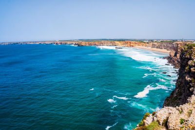 Scenic view of sea against clear blue sky