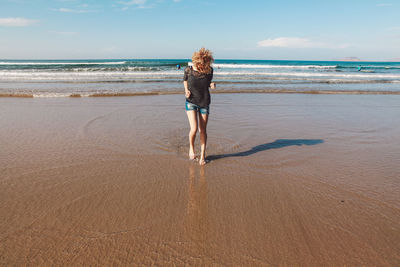 Young woman walking at beach