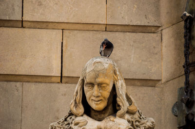 Statue against wall