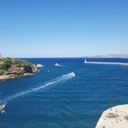 Scenic view of sea against clear blue sky