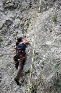 Low angle view of woman rock climbing