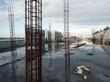 Reflection of built structure in puddle