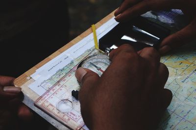 Midsection of man holding paper