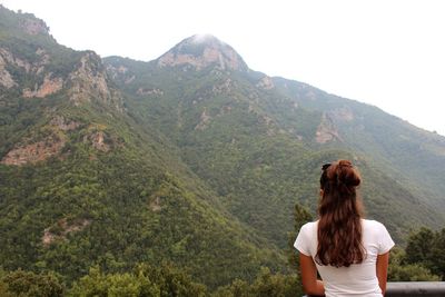 Rear view of woman looking at mountains