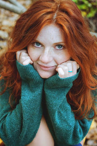 Close-up portrait of a smiling young redhead woman