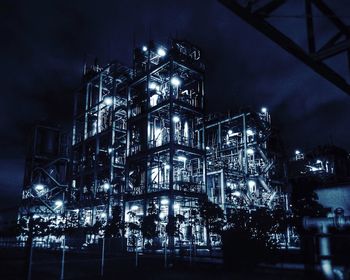 Low angle view of illuminated building against sky at night