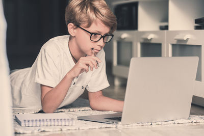 Boy using laptop at home