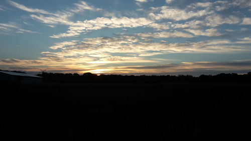 Silhouette landscape against sunset