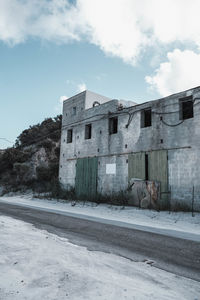 Abandoned building against sky in city