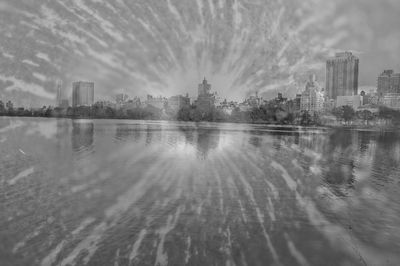 Panoramic view of lake and buildings against sky