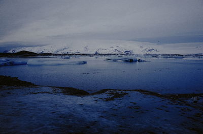 Scenic view of frozen lake against sky
