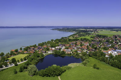 High angle view of buildings by sea against sky