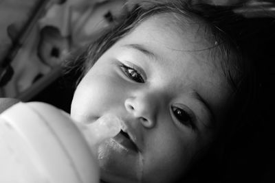 High angle portrait of cute girl with baby bottle