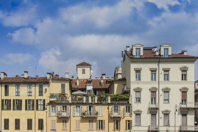 Low angle view of building against cloudy sky