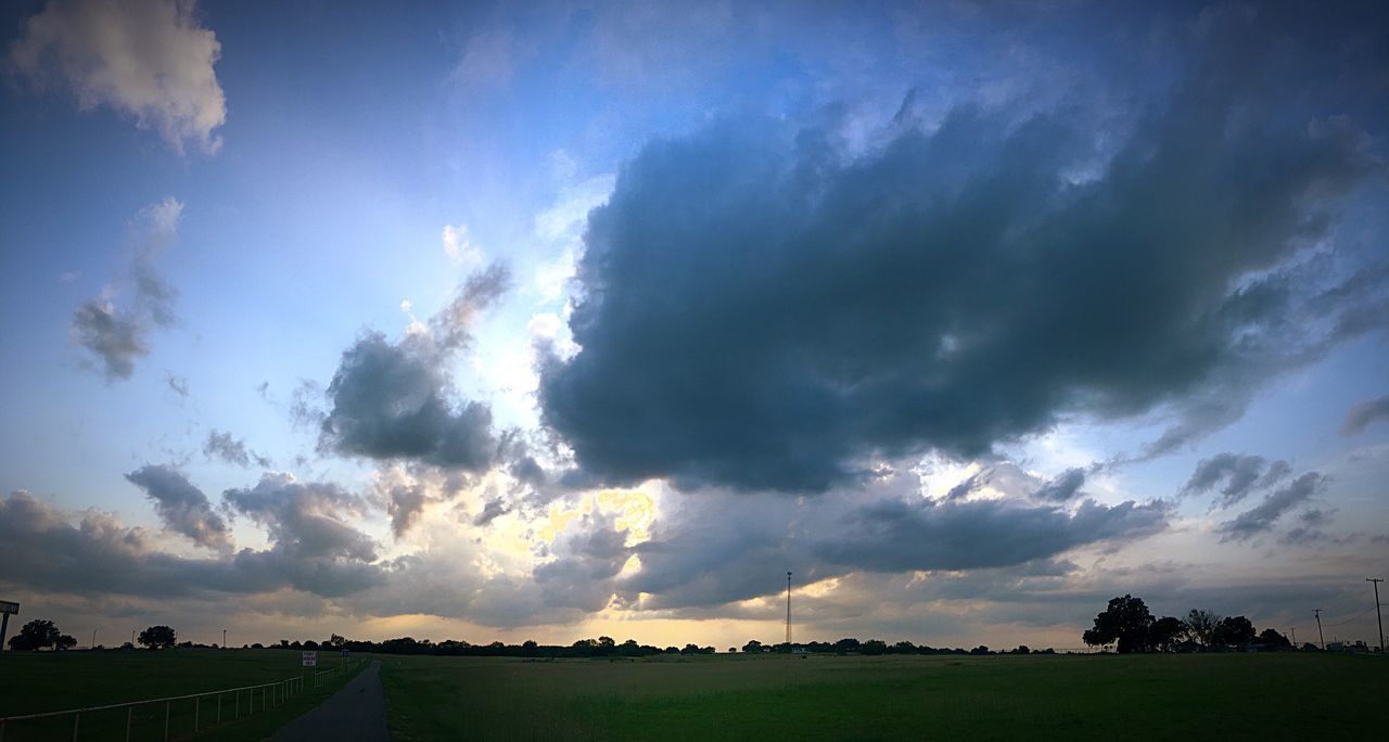 sky, tranquil scene, cloud - sky, landscape, tranquility, scenics, beauty in nature, cloudy, field, nature, cloud, idyllic, weather, blue, grass, cloudscape, horizon over land, dramatic sky, outdoors, non-urban scene