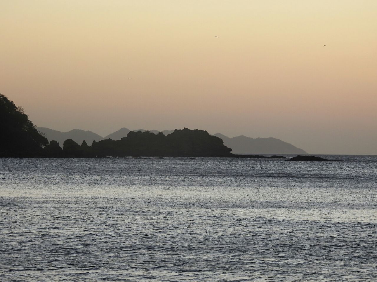 water, sky, beauty in nature, scenics - nature, waterfront, sea, sunset, tranquil scene, tranquility, mountain, idyllic, no people, nature, silhouette, non-urban scene, orange color, clear sky, copy space, outdoors