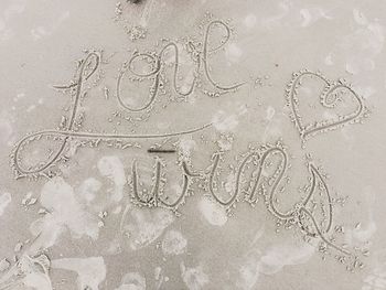 Text on sand at beach