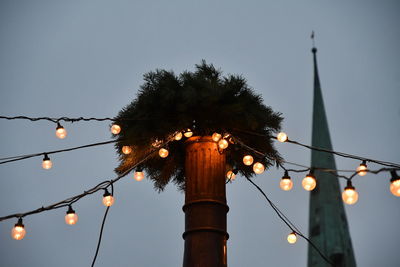 Low angle view of illuminated street light against sky