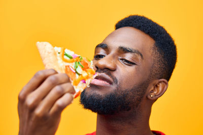 Side view of young man eating food