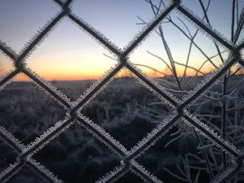 Close-up of metal against sky during sunset