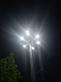 Low angle view of illuminated street light against sky at night