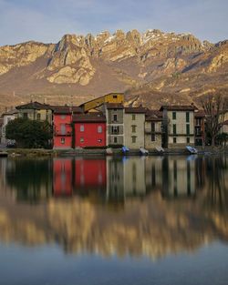 Reflection of houses and mountains in lake