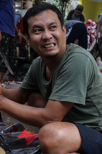 Portrait of man sitting outdoors