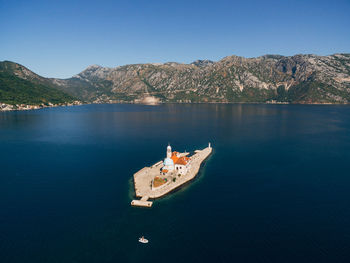 Scenic view of lake and mountains against clear sky