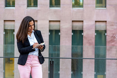 Full length of woman using mobile phone