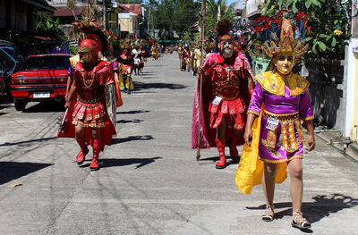 Rear view of women walking on street in city