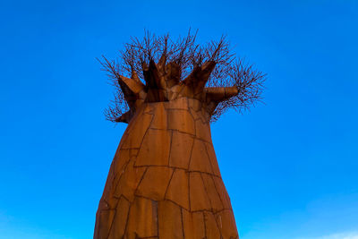 Low angle view of tree against clear blue sky