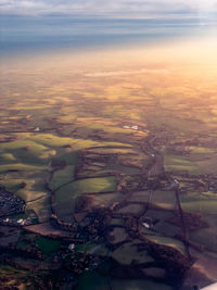 Aerial view of sea against sky during sunset