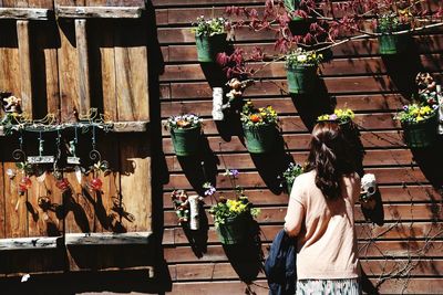 Midsection of woman standing by plants