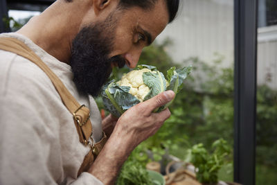 Man smelling fresh cauliflower