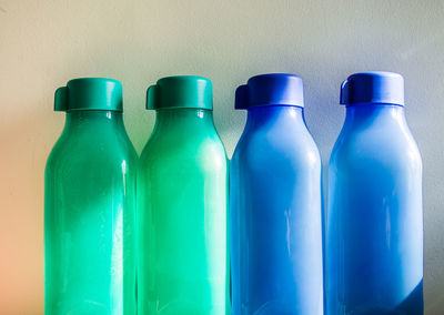 Close-up of empty bottle against blue background