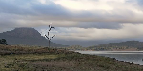 Scenic view of land and mountains against sky