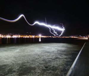 Illuminated city against sky at night