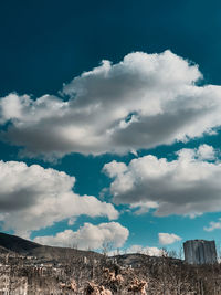 Low angle view of buildings against cloudy sky