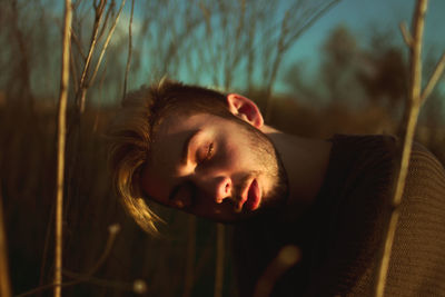 Close-up of young man in trees