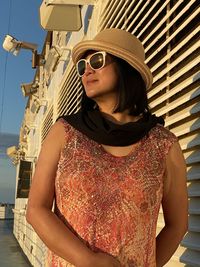 Young woman wearing sunglasses standing outdoors