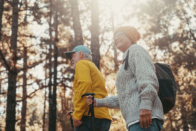 Rear view of woman standing in forest