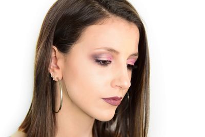 Close-up portrait of a beautiful young woman over white background