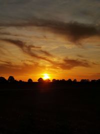 Scenic view of silhouette landscape against romantic sky at sunset